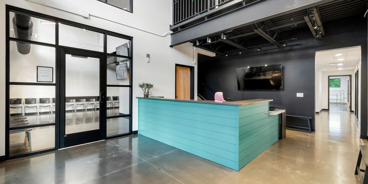 The attractive, entryway-facing front desk at Springs Dance West