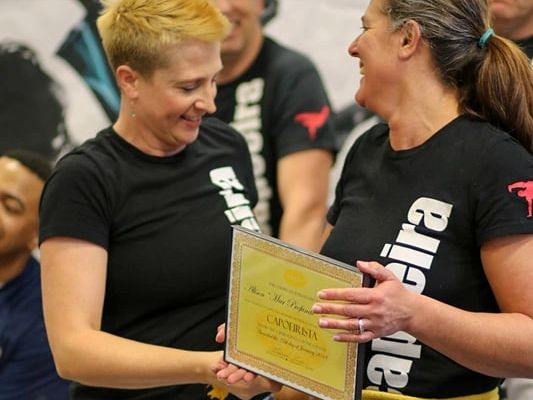 An adult woman increasing her self-confidence through rank advancements. 