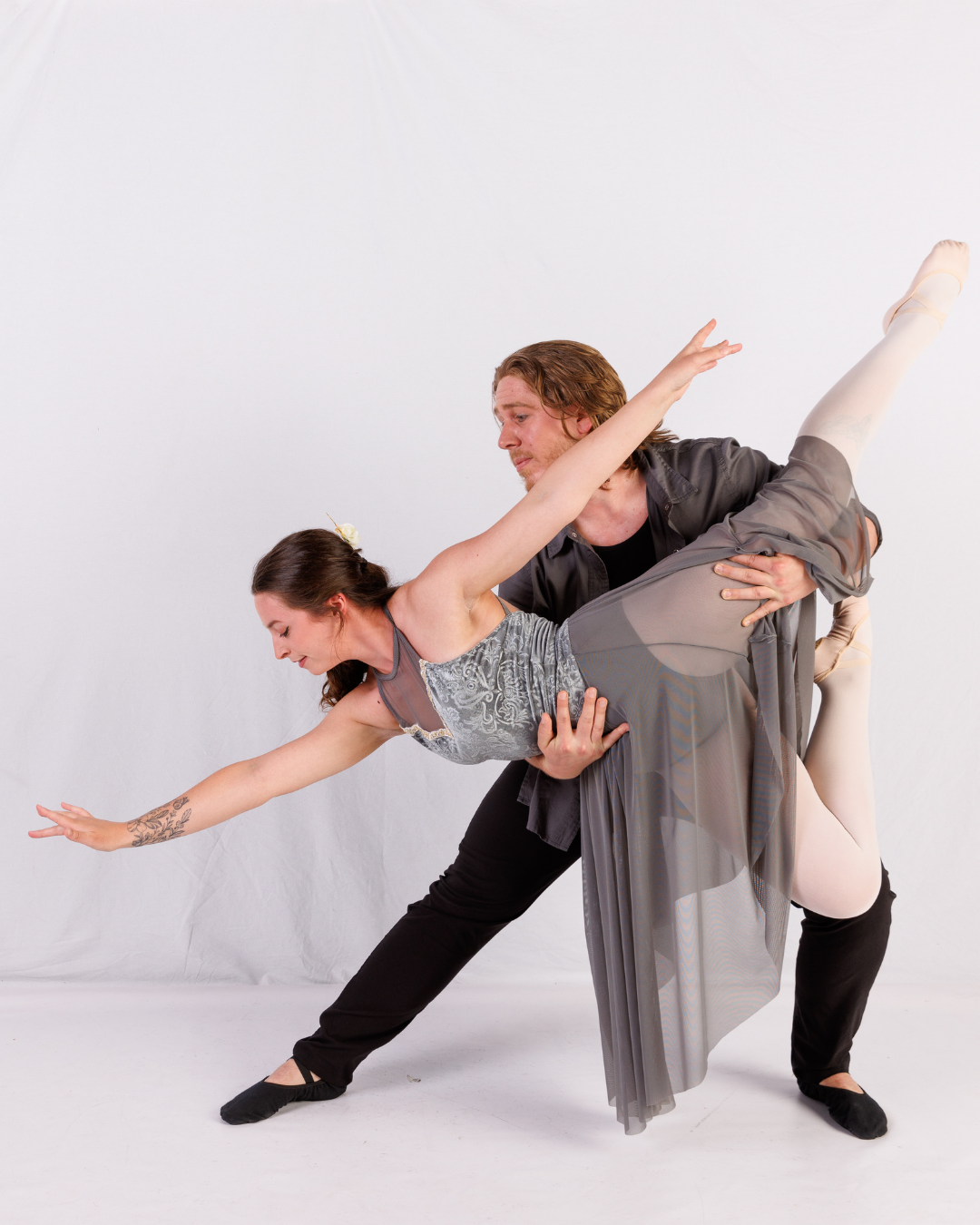 a male dancer showing a lift with a female dancer