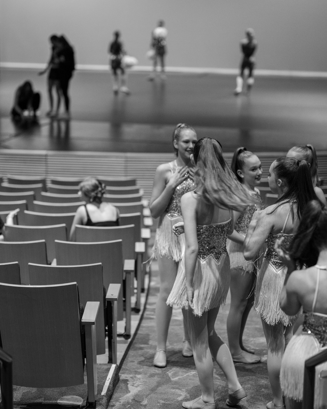 a black and white photo of a group of young dancers at rehearsal