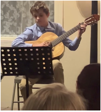 Student on stage for recital performance.