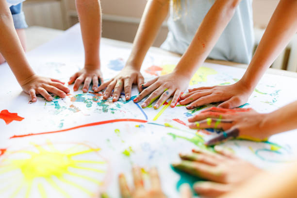 Teacher and children engaged in creative learning activities